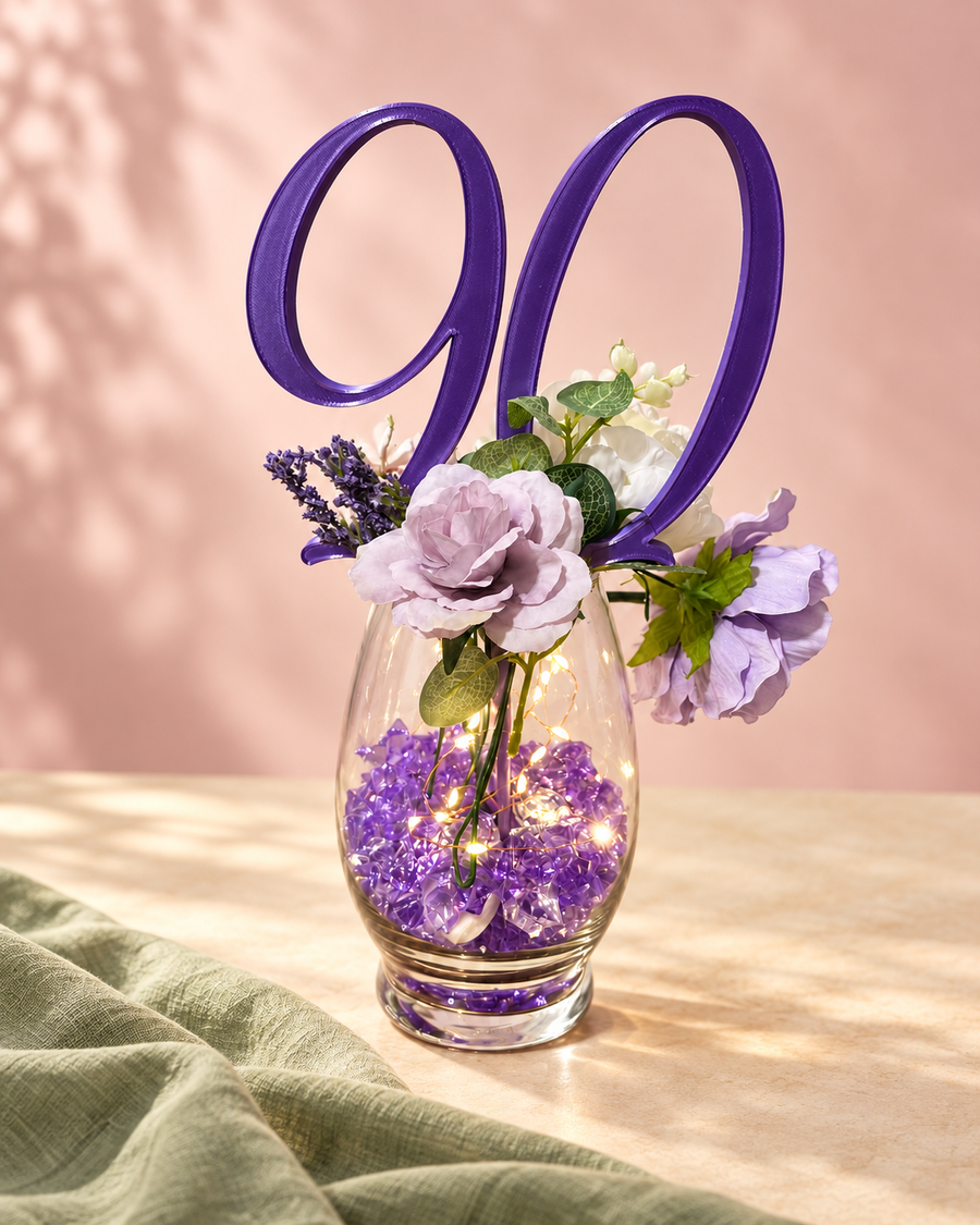 Purple 90 centerpiece pick in a floral arrangement on blush and cream